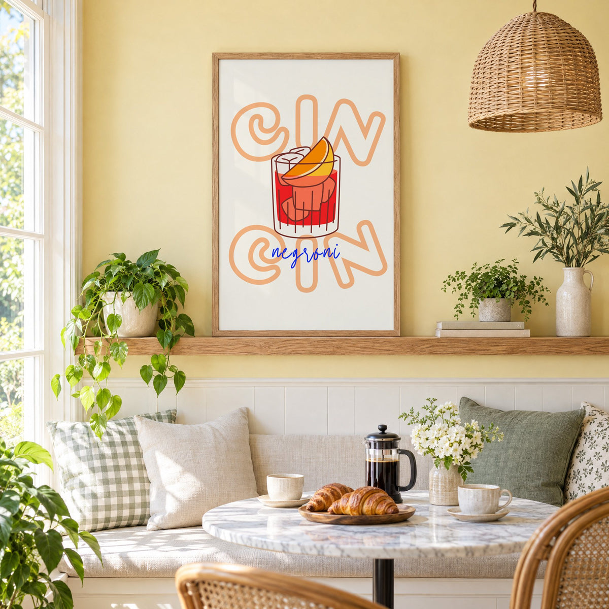 Cin Cin negroni orange slice print in an oak frame on a picture ledge above a sunny breakfast nook