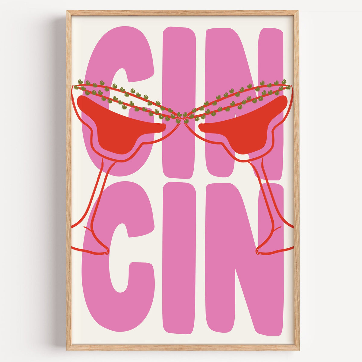 Cin cin pink coupe print in a light oak frame on a plain white wall