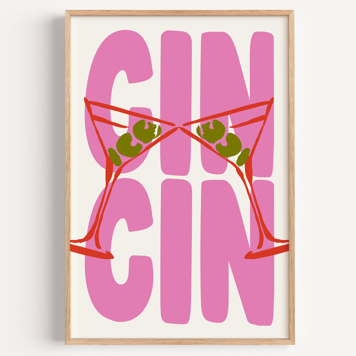 Cin cin red martini print in a light oak frame on a plain white wall