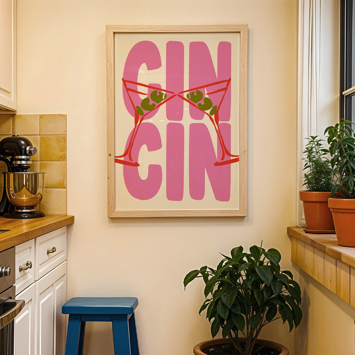 Cin cin red martini print in a wood frame on a yellow tiled kitchen wall