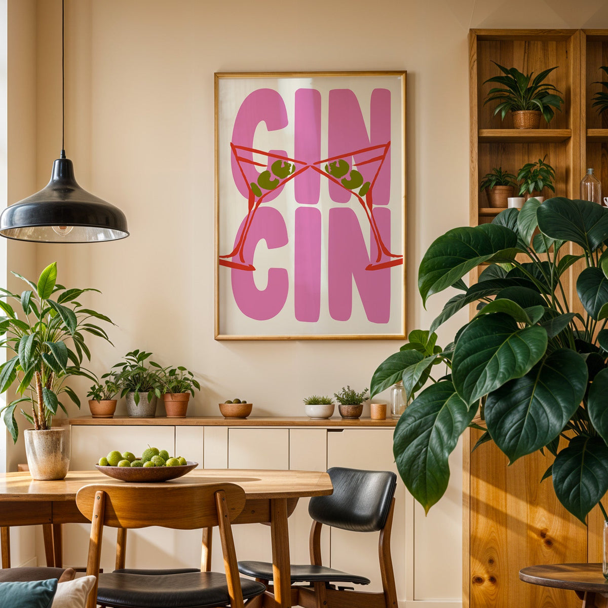 Cin cin red martini print in an oak frame above a sideboard in a plant-filled dining room