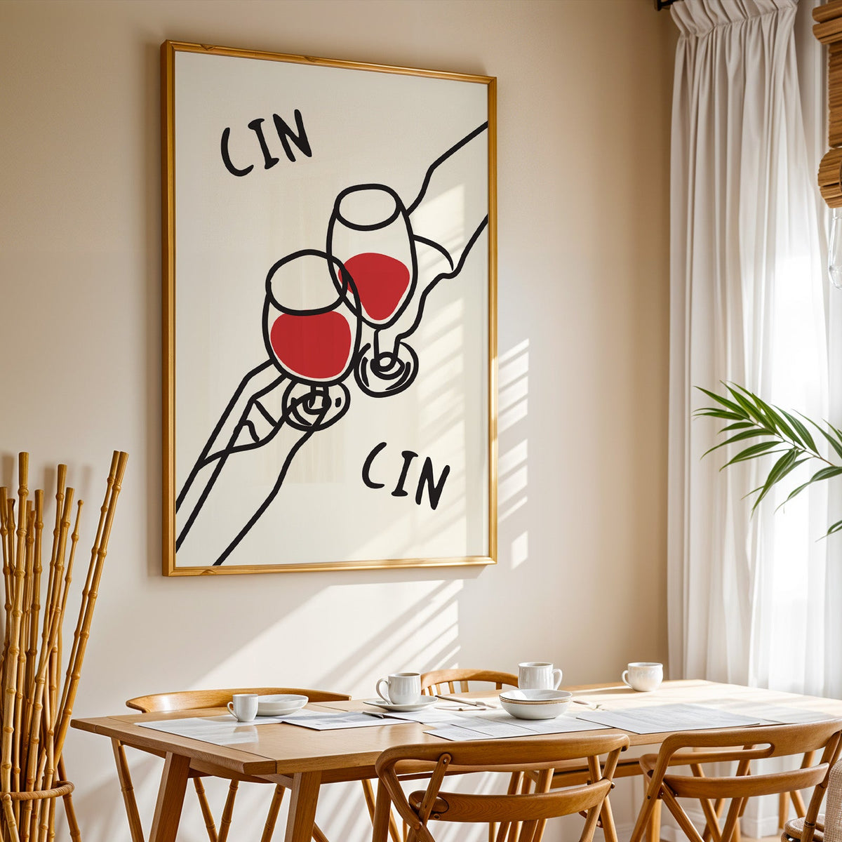 Cin cin red wine line art print in a gold frame above a sunlit breakfast table