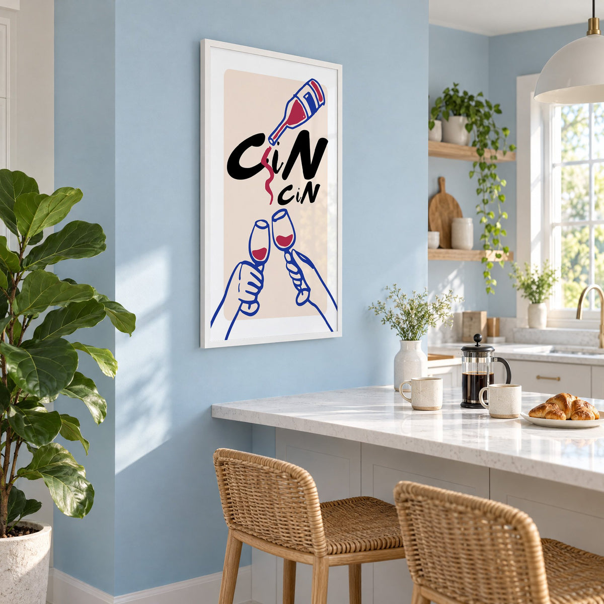 CiN CiN red wine toast print in a white frame on a pale blue wall above a breakfast bar with rattan stools