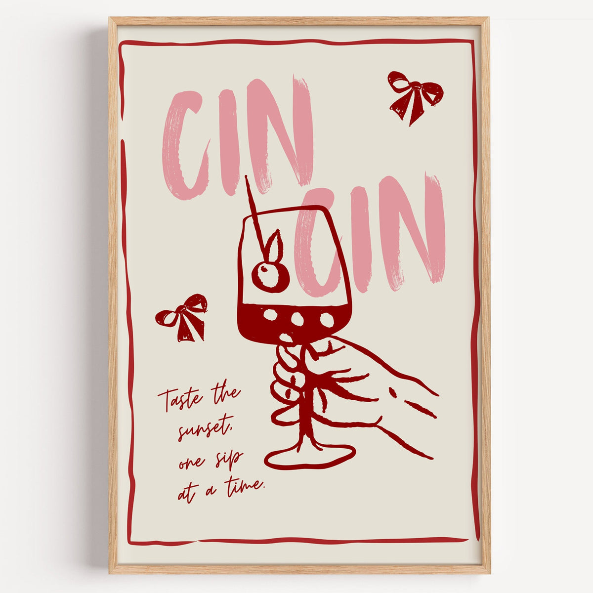 Cin Cin wine print in a light oak frame on a plain white wall