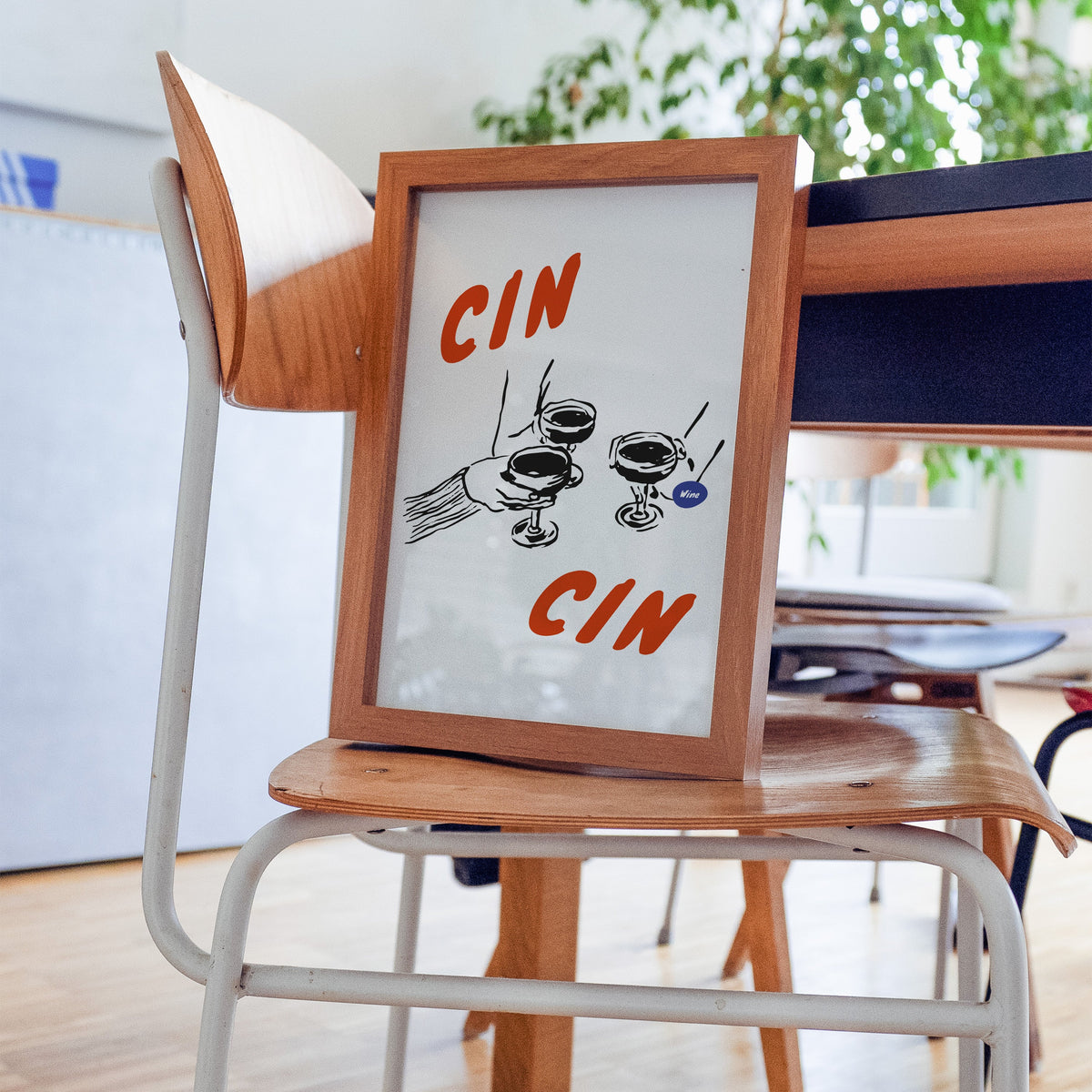Cin Cin espresso martini print in a walnut frame on a bentwood chair