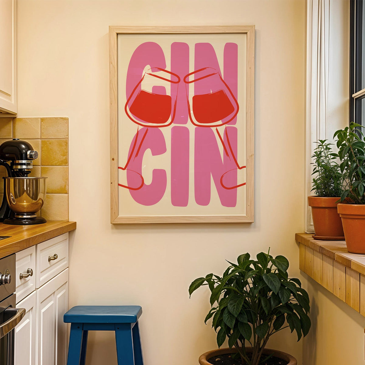 Cin cin wine glasses print in a wood frame on a yellow tiled kitchen wall
