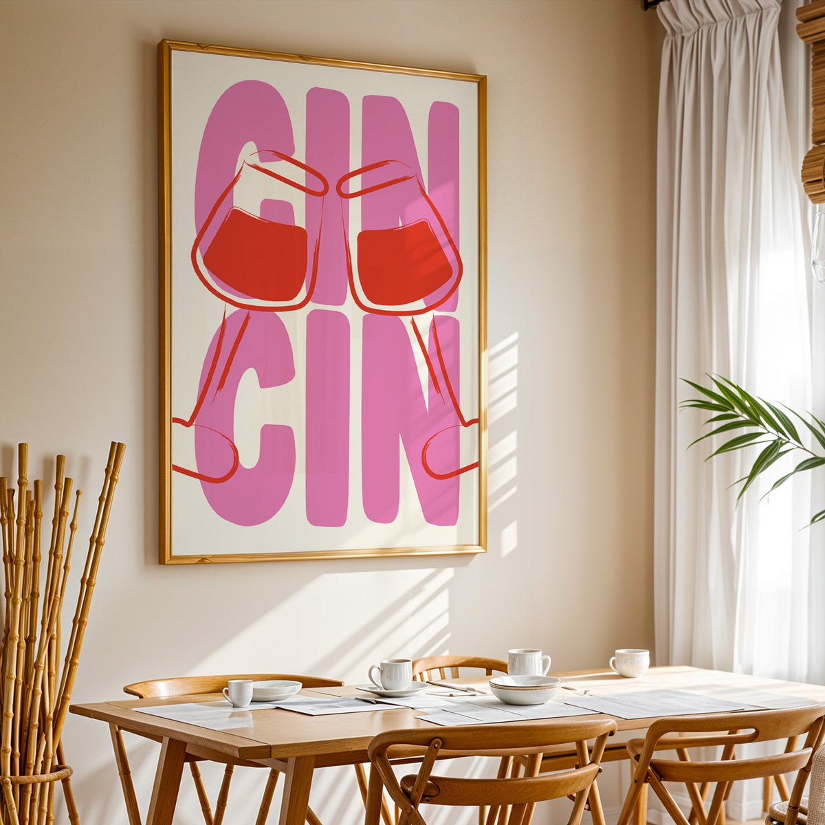 Cin cin wine glasses print in a gold frame above a sunlit breakfast table