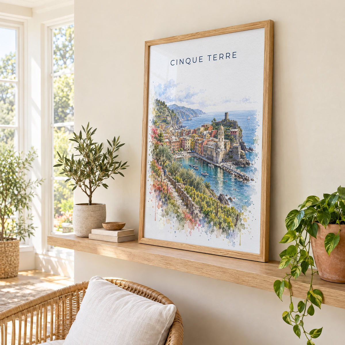 Cinque Terre watercolor print in an oak frame on a picture ledge in a sunlit sunroom