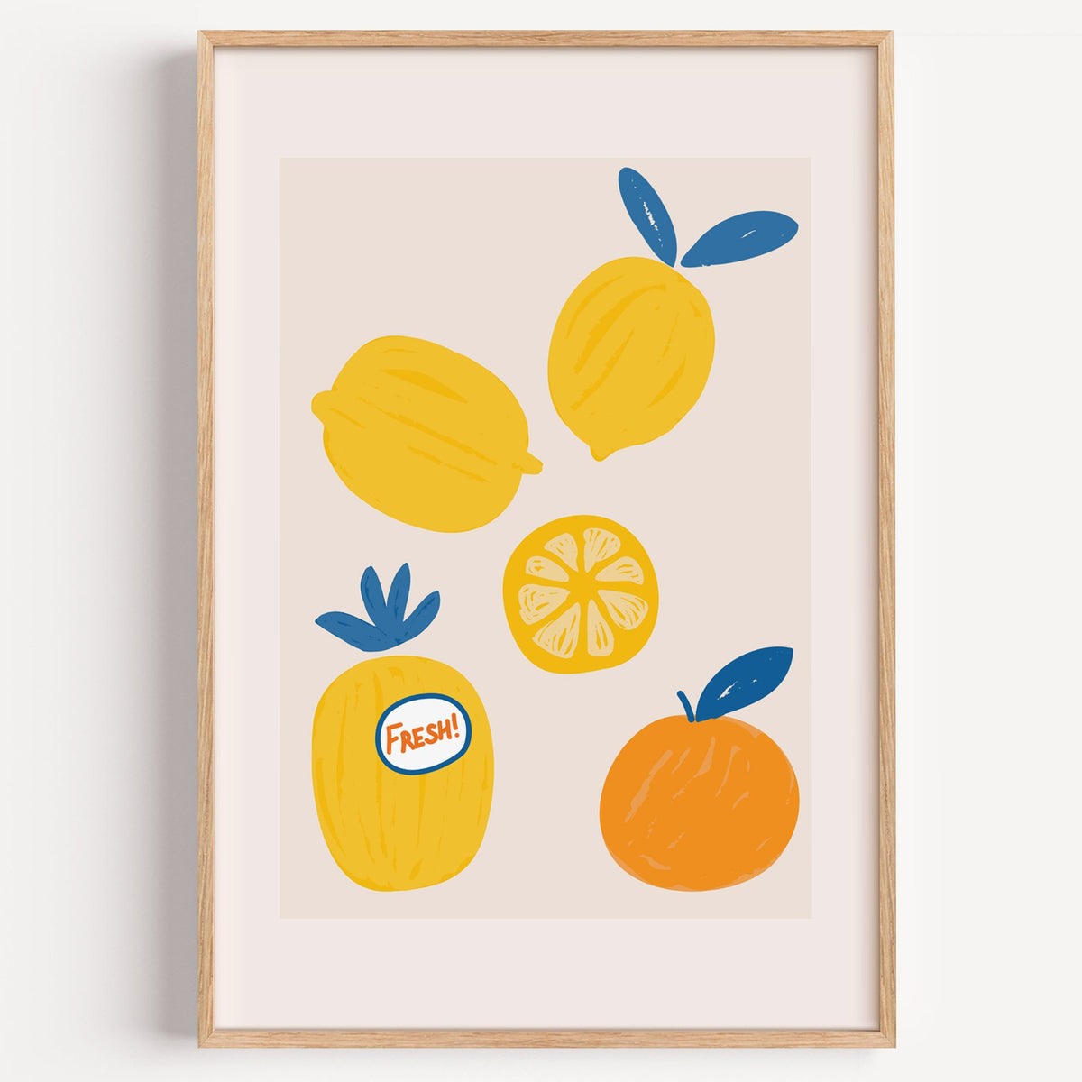 FRESH! sticker lemons and orange print in a light oak frame on a plain white wall