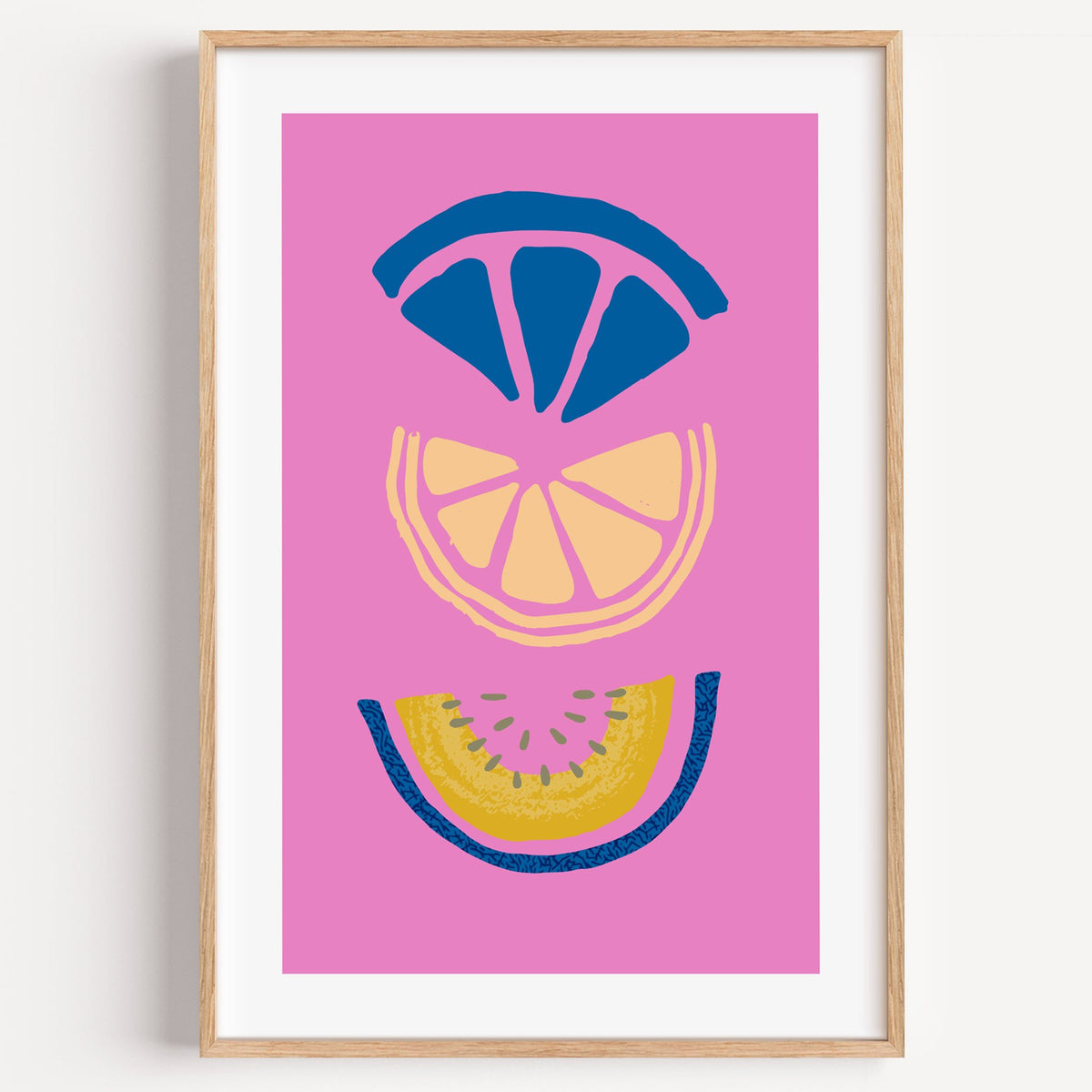stacked citrus and melon slices hot pink print in a light oak frame on a plain white wall