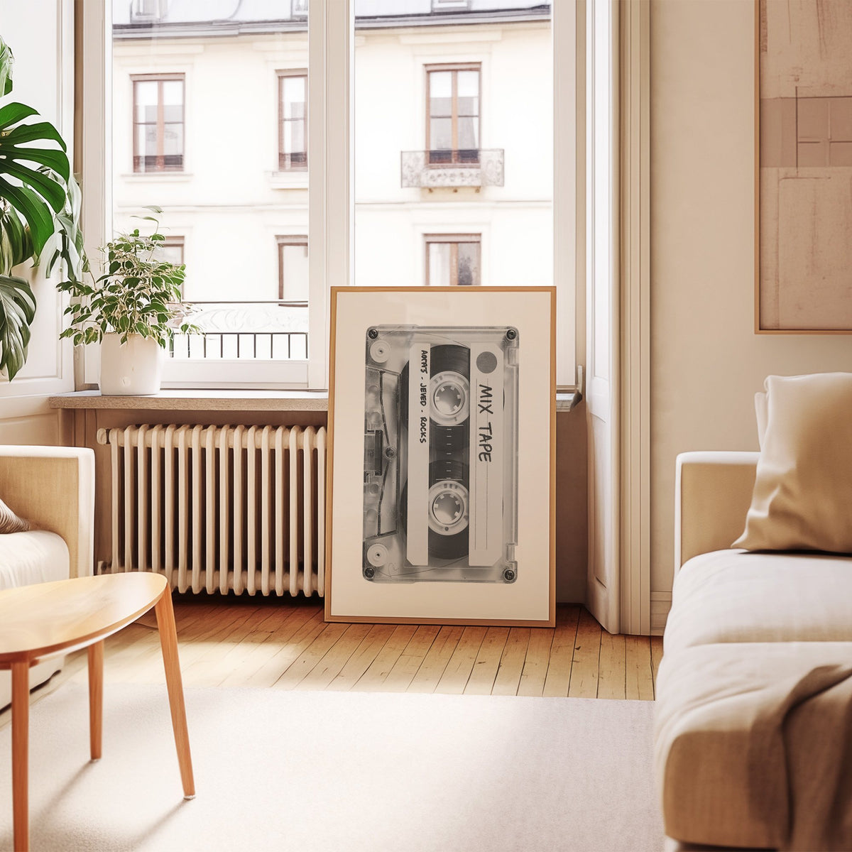 Clear mix tape cassette with handwritten label print in an oak frame leaning by a French window in a living room