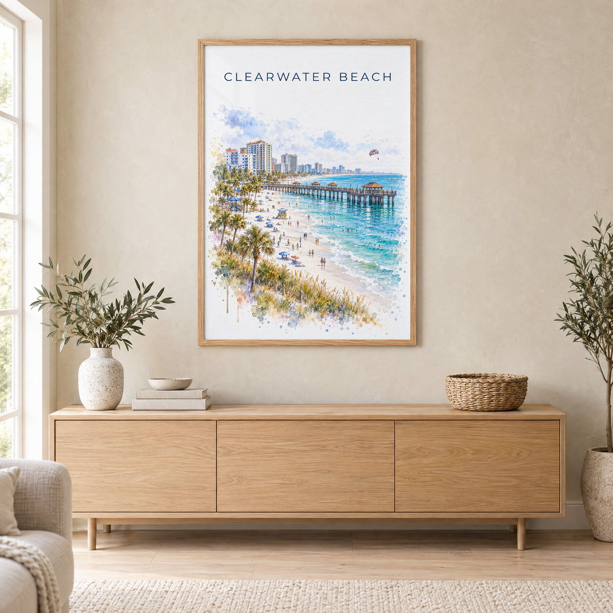 Clearwater Beach watercolor print in an oak frame above a light wood sideboard in a Scandinavian living room