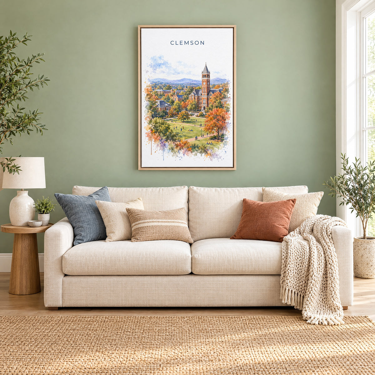 Clemson watercolor print as a natural floater canvas above a cream linen sofa on a sage green wall