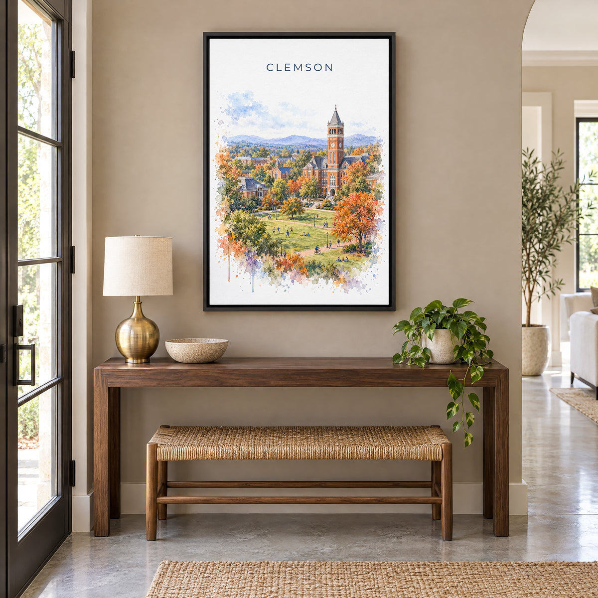 Clemson watercolor print as a black floater canvas above a walnut console and woven bench in an entryway
