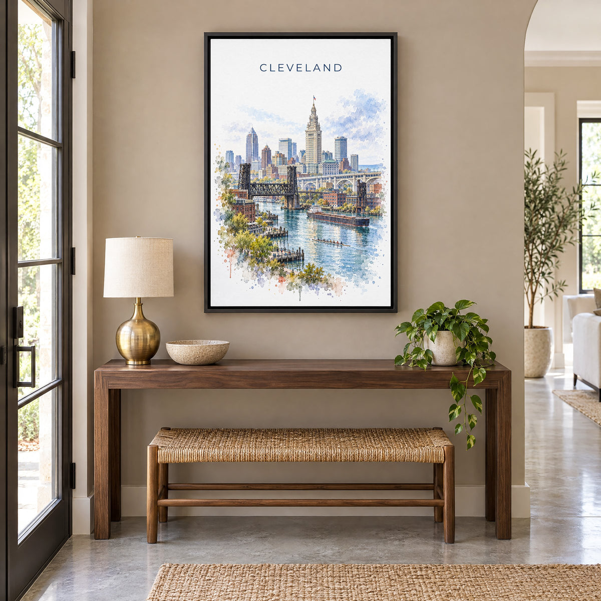Cleveland watercolor print as a black floater canvas above a walnut console and woven bench in an entryway