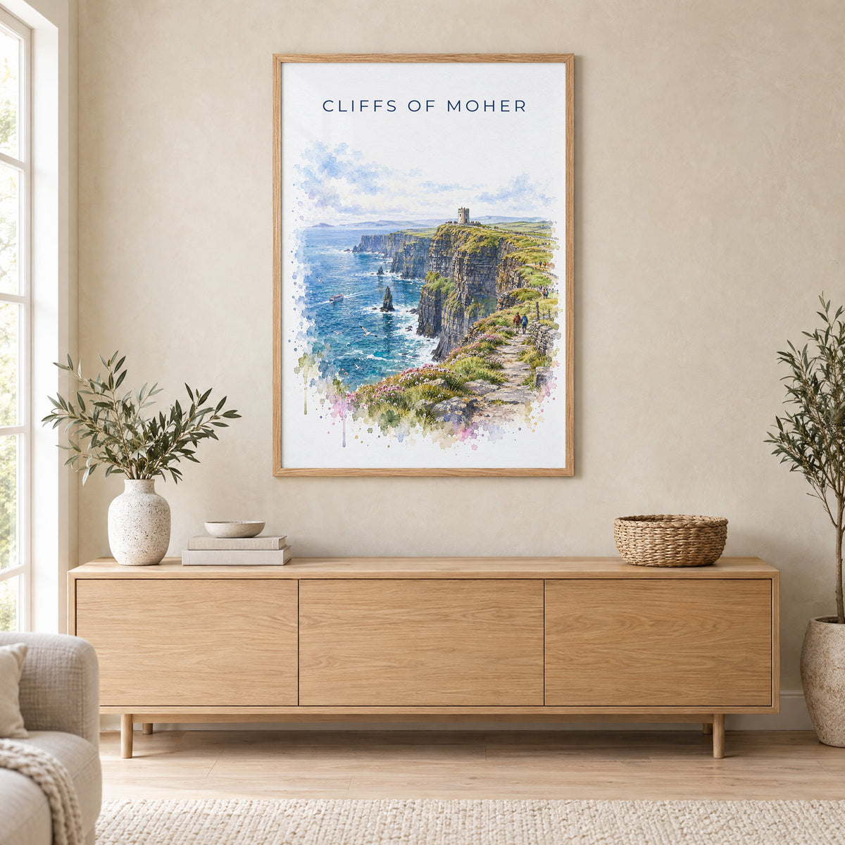 Cliffs of Moher watercolor print in an oak frame above a light wood sideboard in a Scandinavian living room