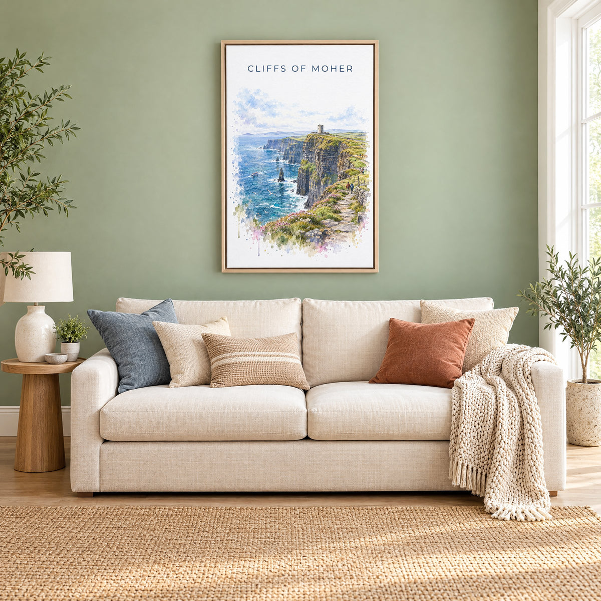 Cliffs of Moher watercolor print as a natural floater canvas above a cream linen sofa on a sage green wall