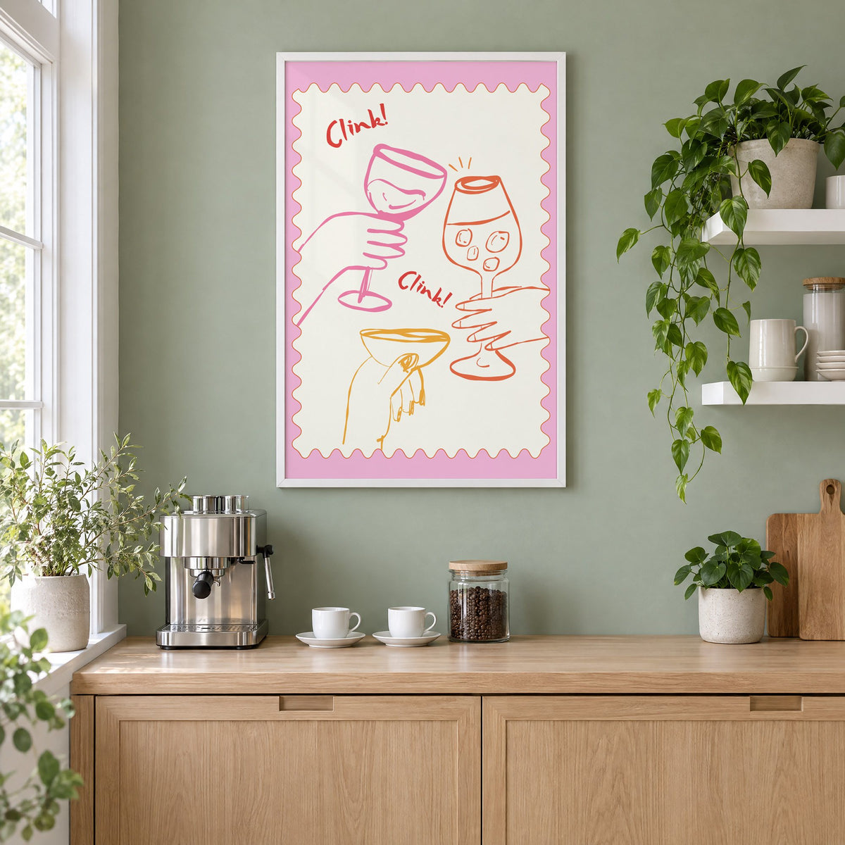 Clink Clink three glasses toast print in a white frame on a sage green coffee nook wall above an espresso machine