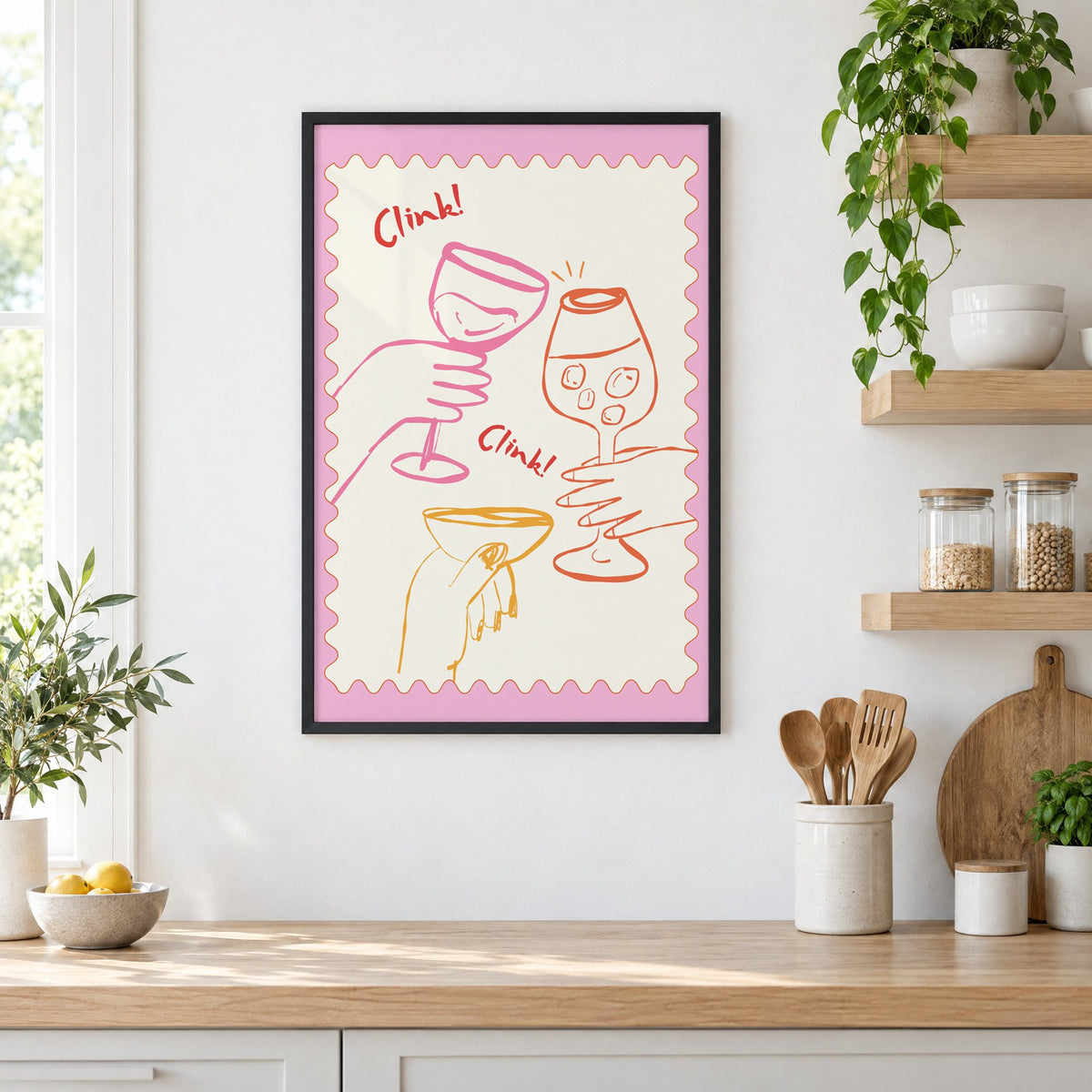 Clink Clink three glasses toast print in a black frame in a white kitchen beside open wood shelves and glass jars