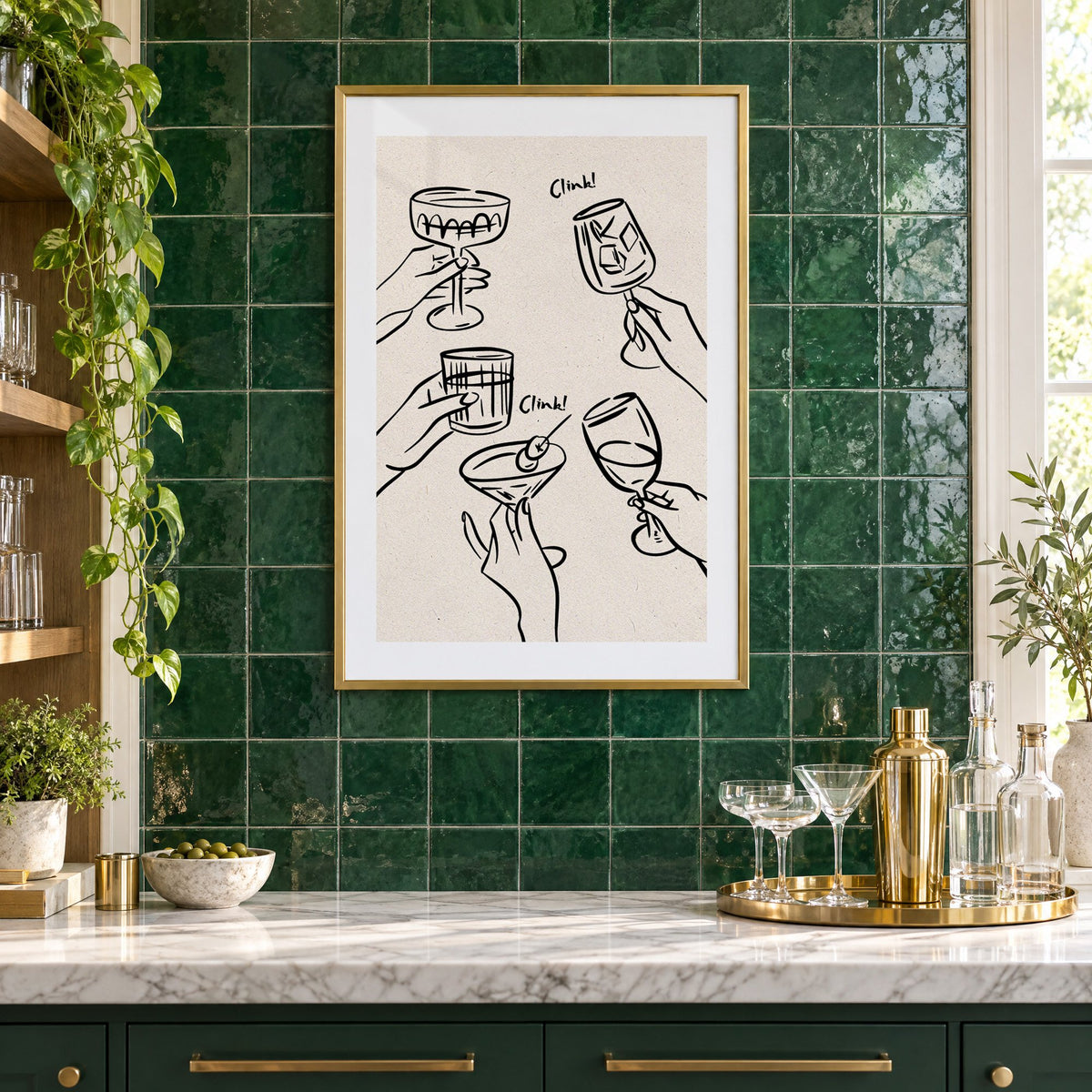 Clink! black line-art cocktail toast print in a brass frame on emerald green tiles above a home bar with coupe glasses