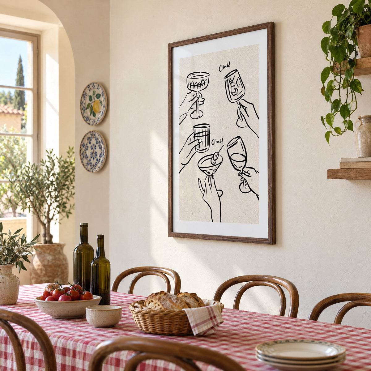 Clink! black line-art cocktail toast print in a walnut frame above a gingham-covered trattoria table, seen at an angle