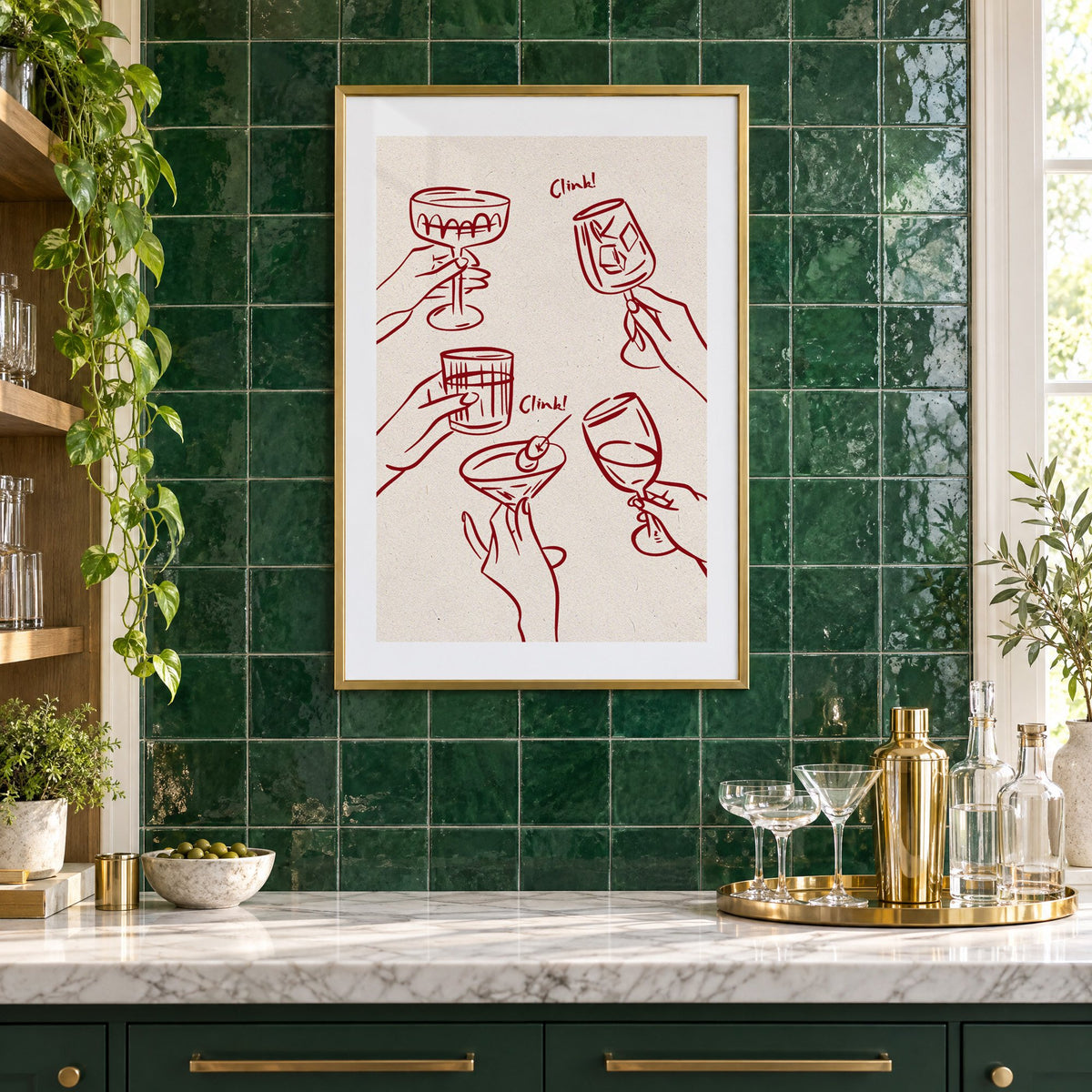 Clink! wine-red cocktail toast print in a brass frame on emerald green tiles above a home bar with coupe glasses