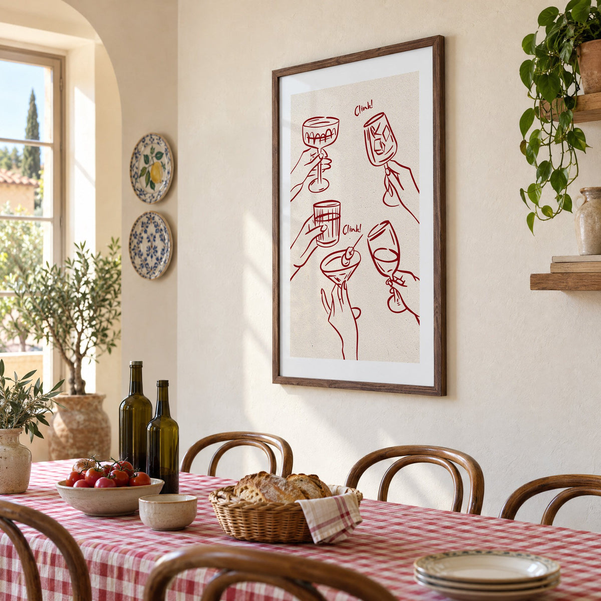 Clink! wine-red cocktail toast print in a walnut frame above a gingham-covered trattoria table, seen at an angle