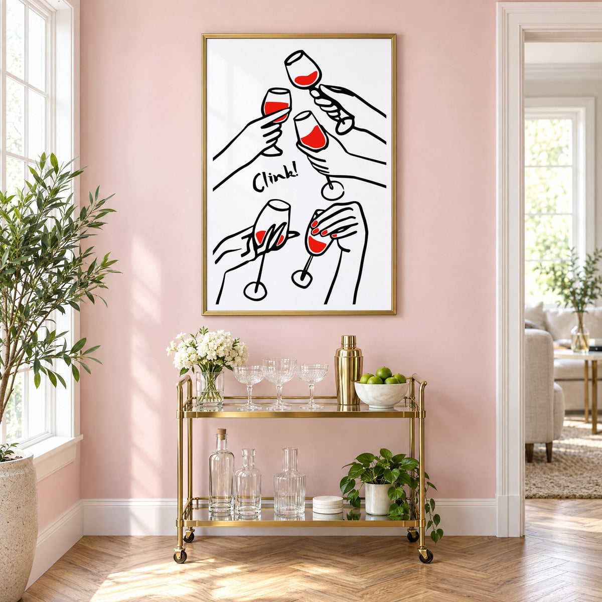 Clink five hands red wine toast print in a brass frame above a gold bar cart on a blush pink wall