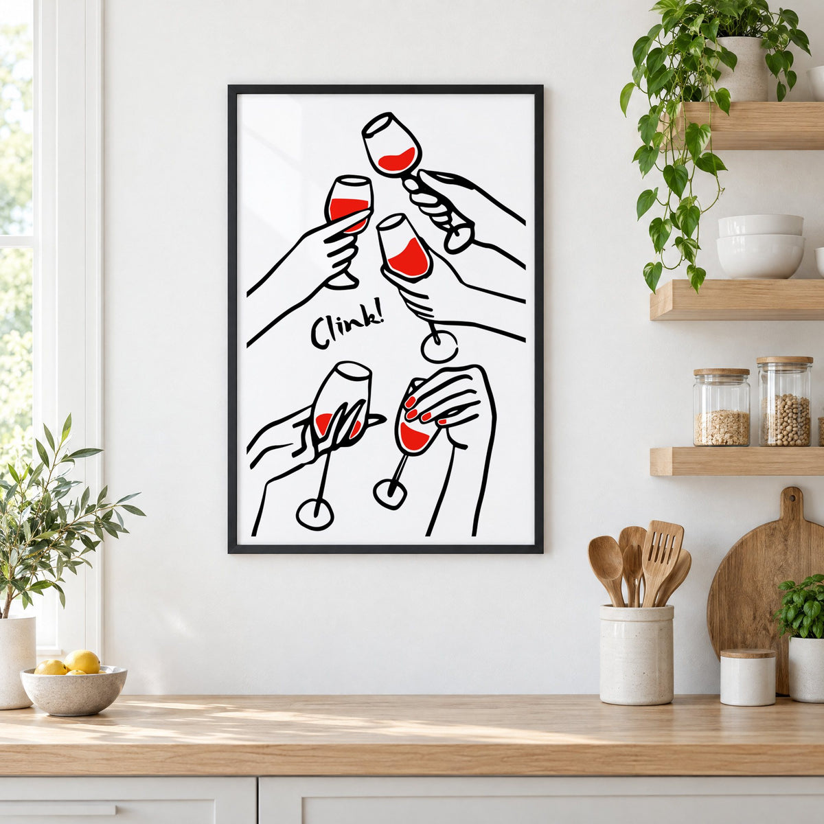 Clink five hands red wine toast print in a black frame in a white kitchen beside open wood shelves and glass jars