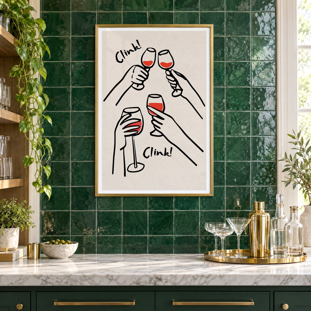 Clink! red wine toast kraft print in a brass frame on emerald green tiles above a home bar with coupe glasses