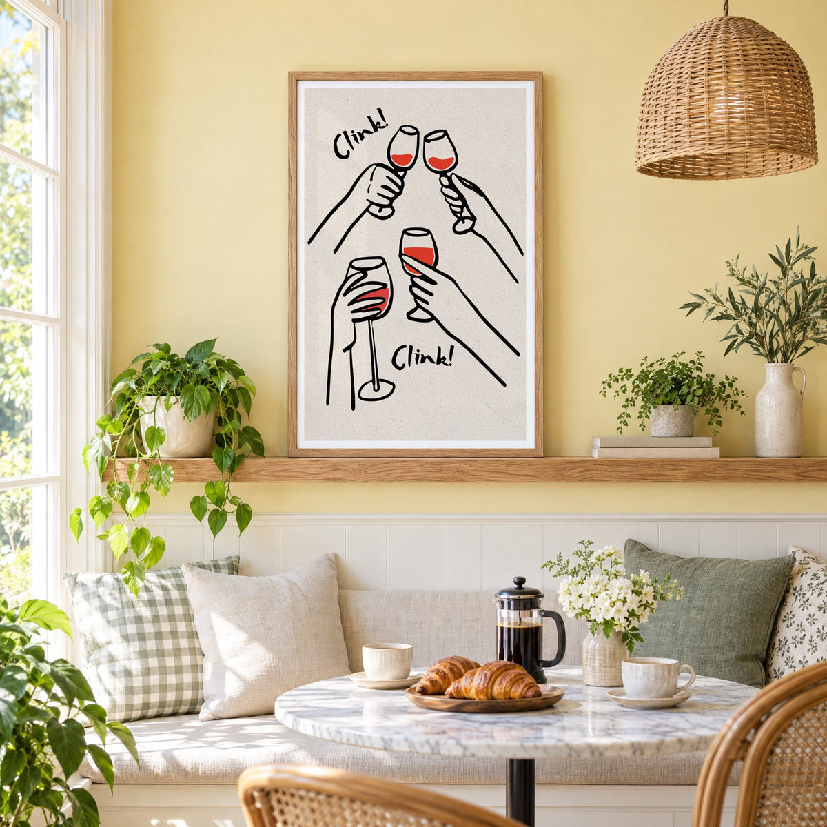 Clink! red wine toast kraft print in an oak frame on a picture ledge above a sunny breakfast nook