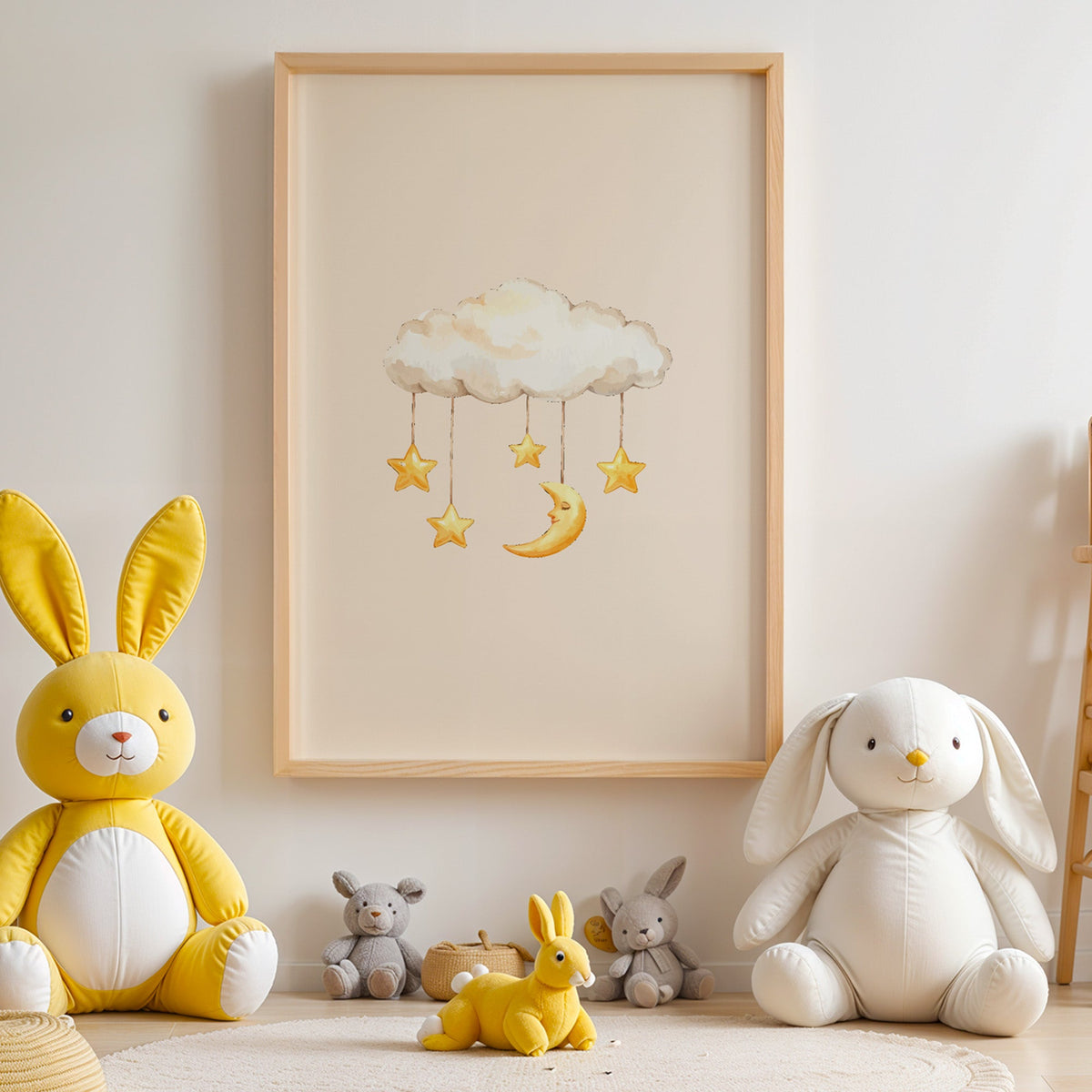 Cloud mobile with moon and stars nursery print in an oak frame above yellow and white plush bunnies