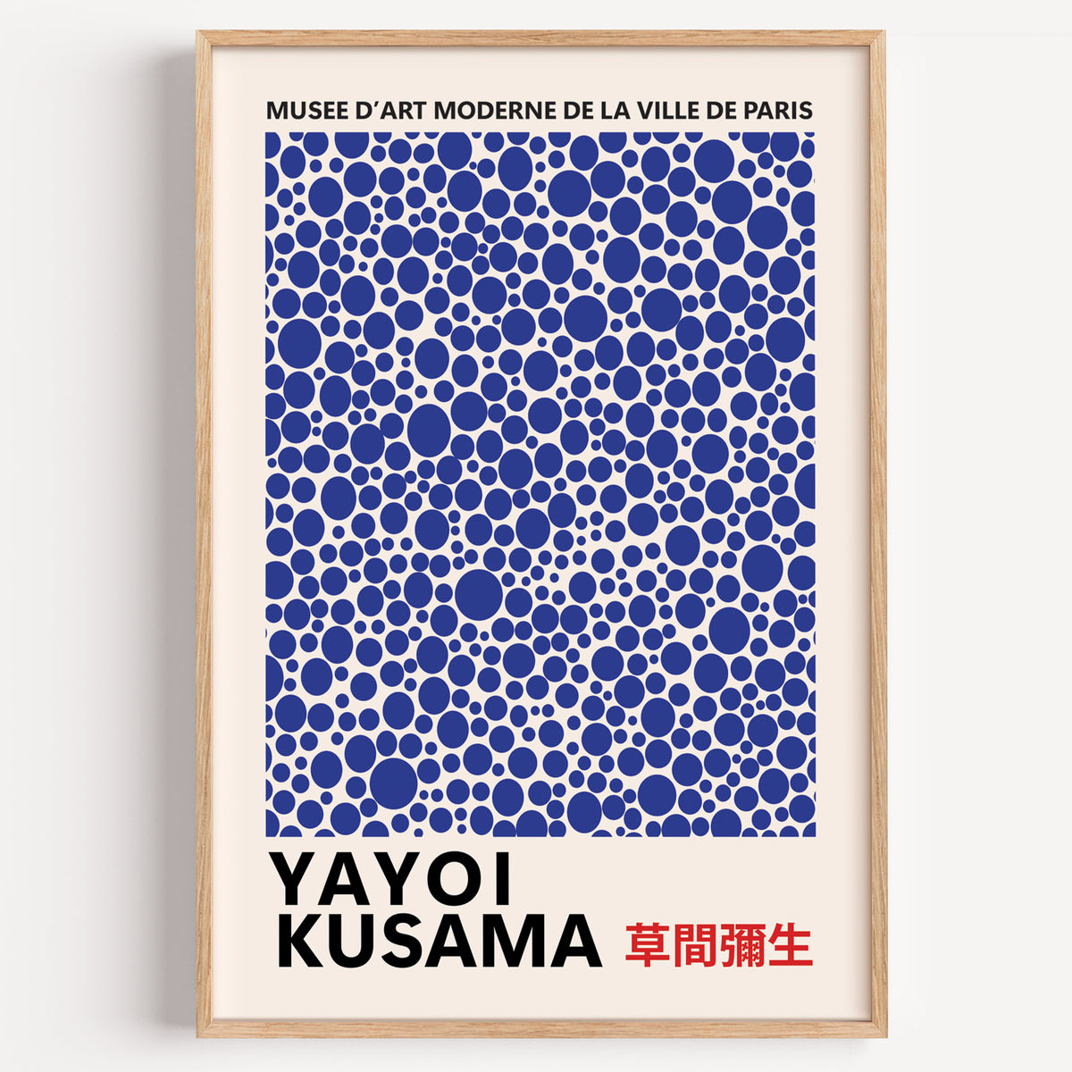 Yayoi Kusama inspired cobalt polka dot print in a wood frame on a plain wall