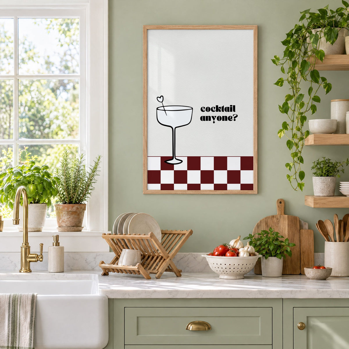 Cocktail anyone coupe check print in an oak frame on a sage green kitchen wall beside a farmhouse sink and herbs