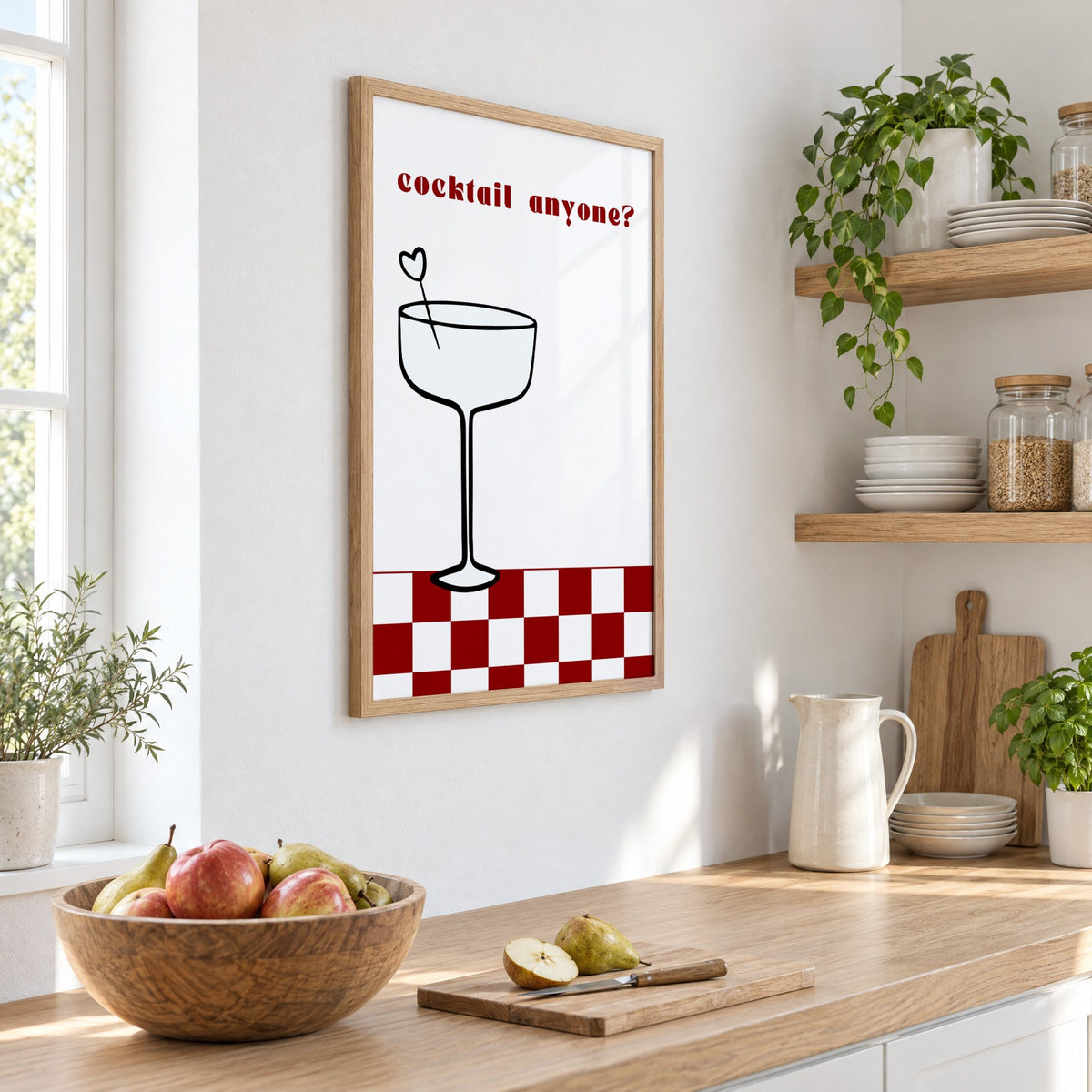 cocktail anyone? coupe check floor print in an oak frame on a white kitchen wall above a counter with apples and pears, seen at an angle