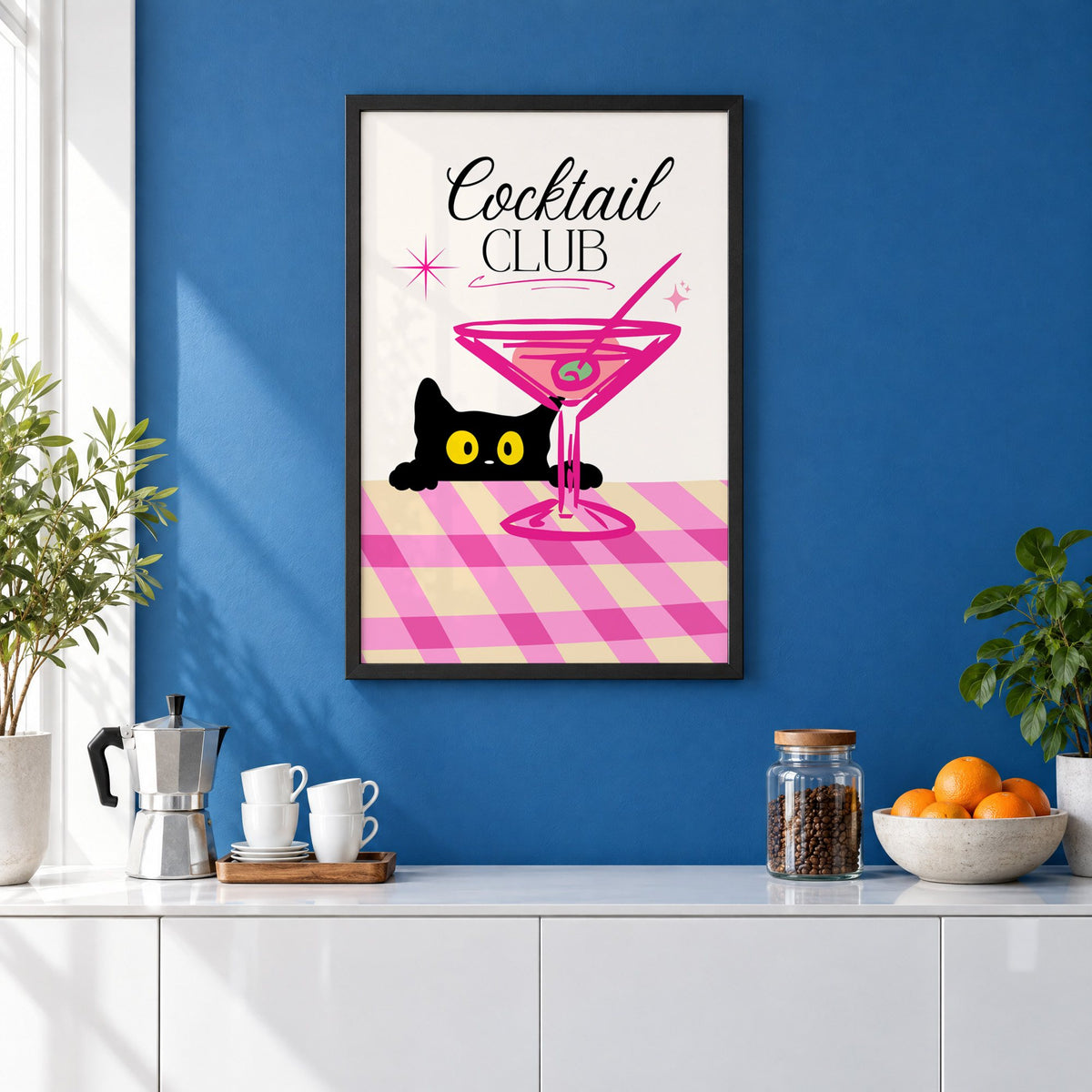 Cocktail Club black cat martini print in a black frame on a cobalt blue wall above a coffee station