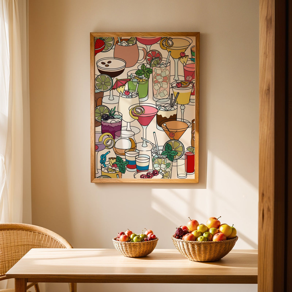 Dense cocktail glasses pattern print in an oak frame above a light wood dining table with baskets of fruit