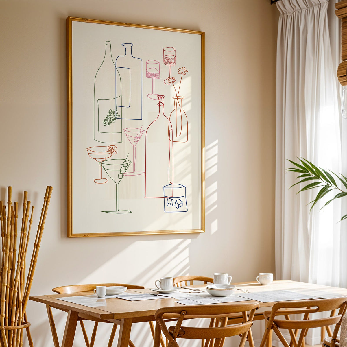 Cocktail glassware line art print in a gold frame above a sunlit breakfast table