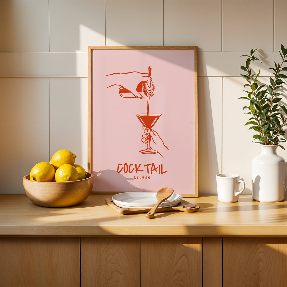 Cocktail Lisbon print in a slim oak frame beside a wooden bowl of lemons
