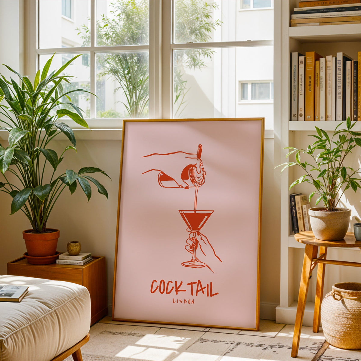 Cocktail Lisbon print in a brass frame resting on a berber rug in a living room