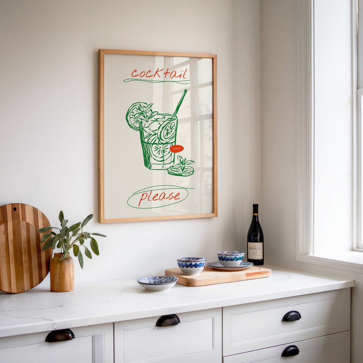 Cocktail Please mojito print in an oak frame above a white kitchen sideboard