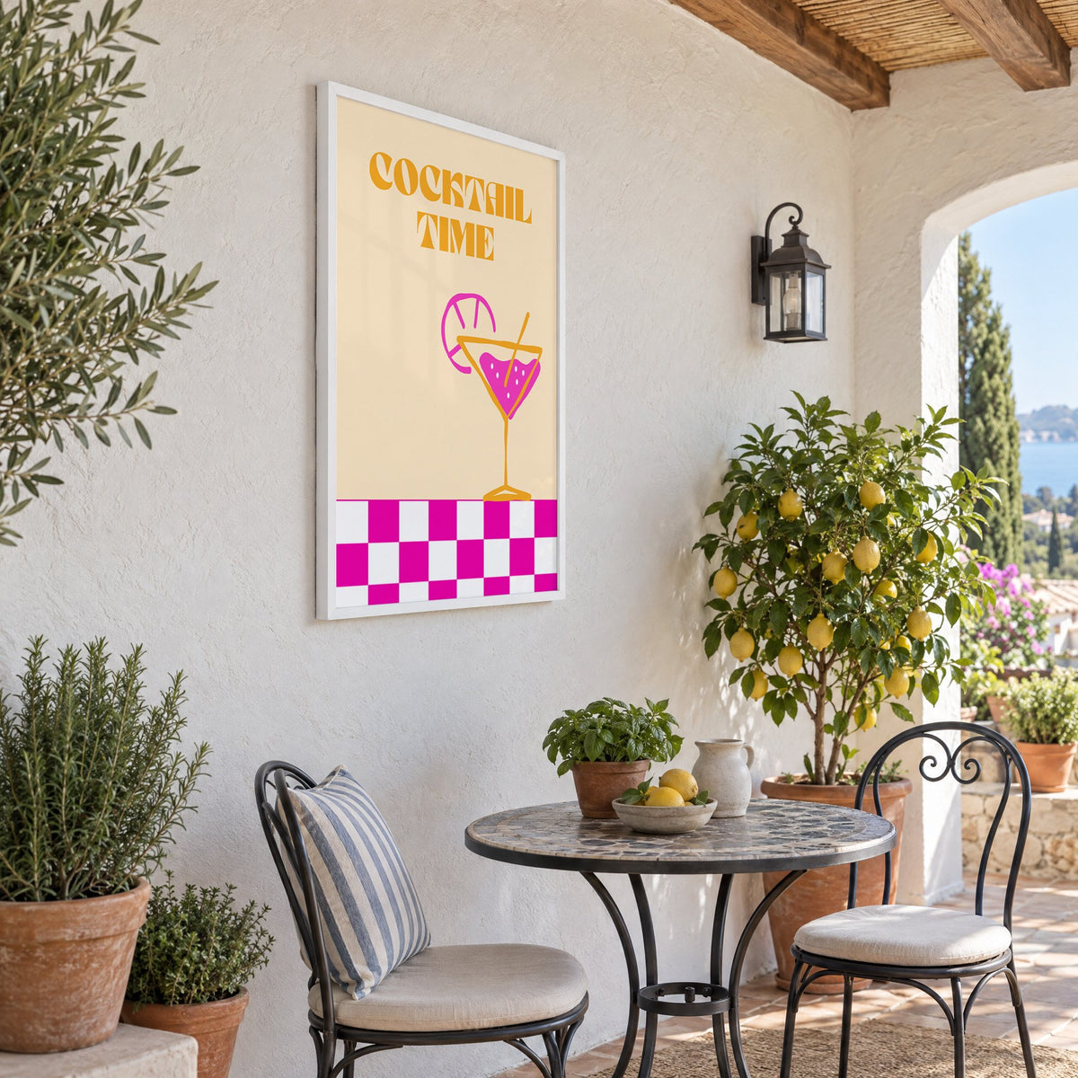 Cocktail Time martini checkerboard print in a white frame on a sunny patio wall beside a potted lemon tree