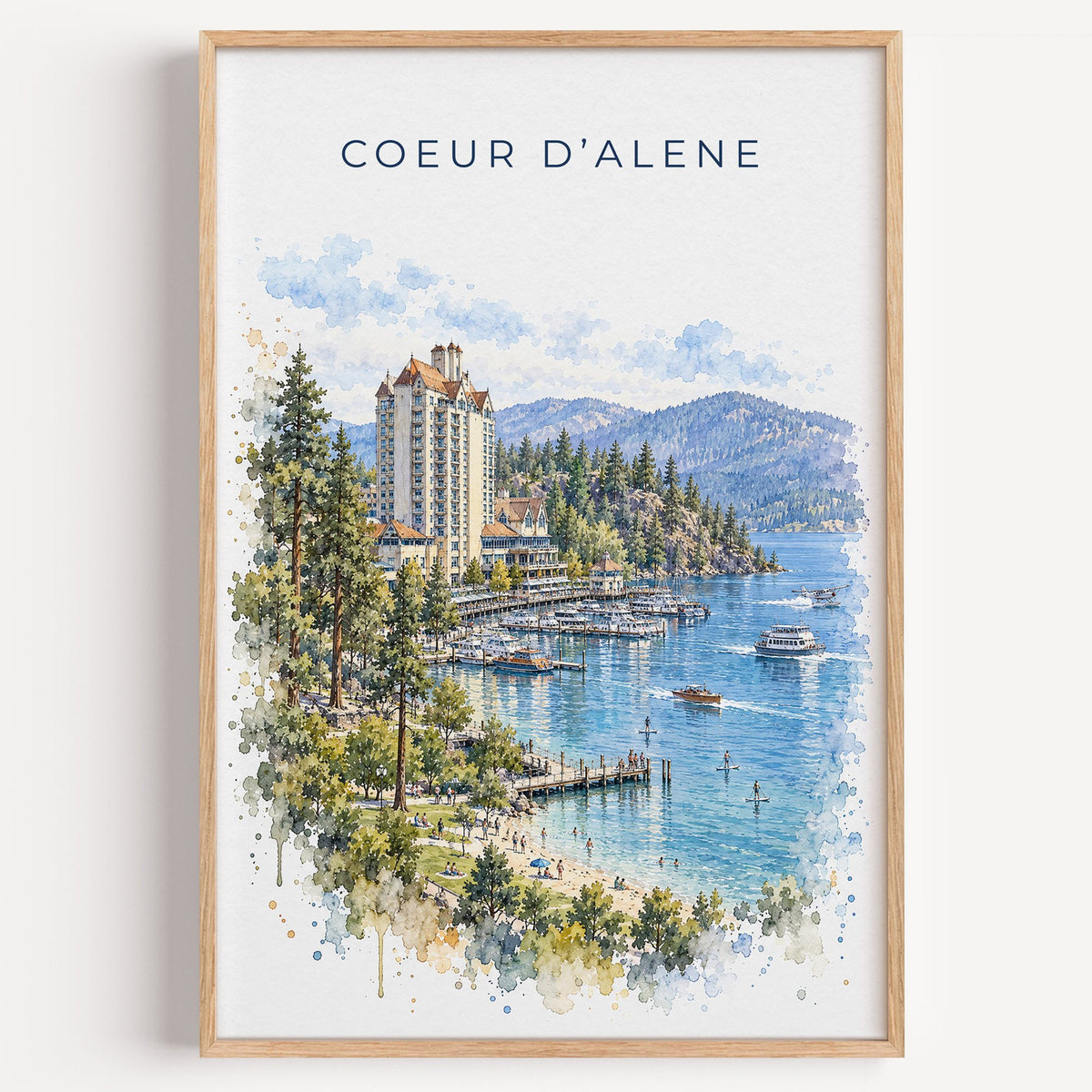 Coeur d'Alene watercolor print in a light oak frame on a plain white wall