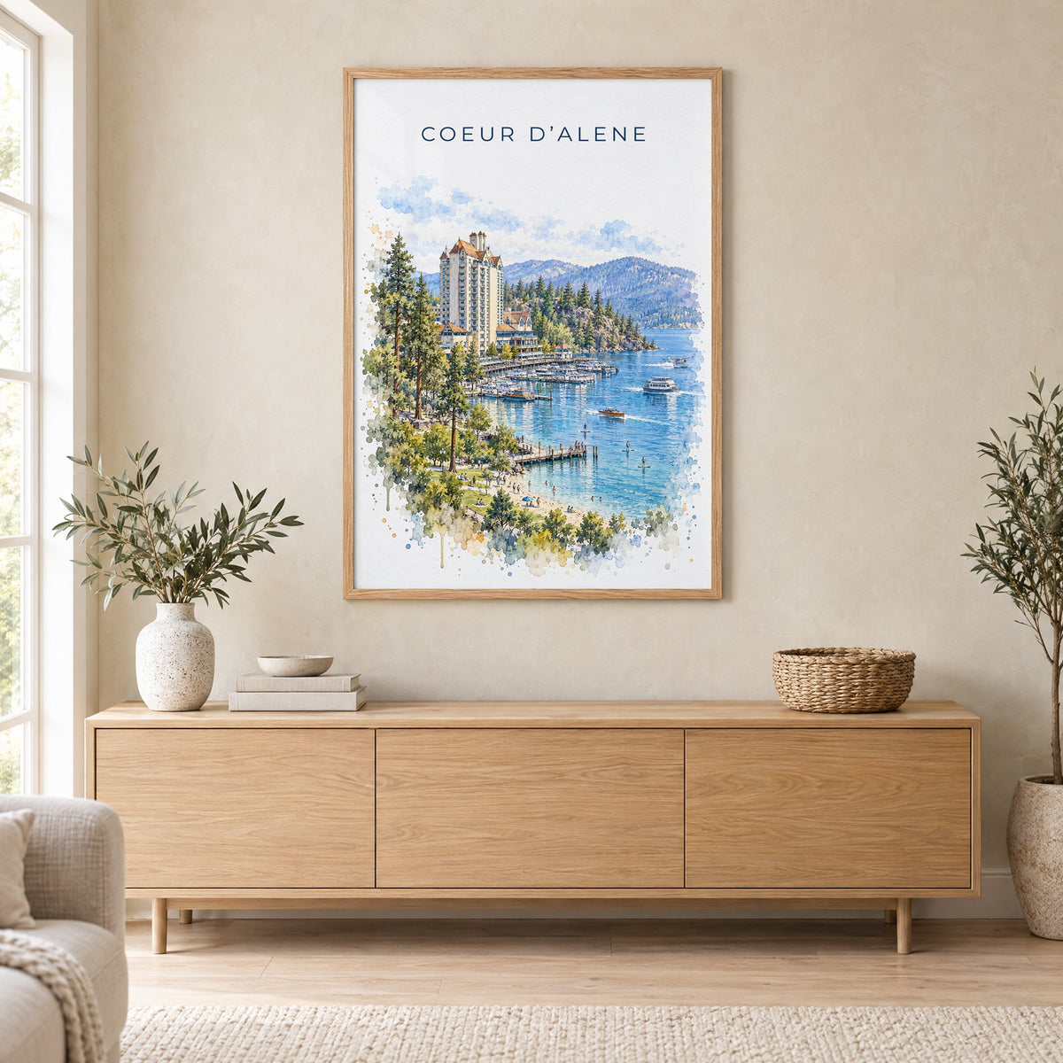 Coeur d'Alene watercolor print in an oak frame above a light wood sideboard in a Scandinavian living room