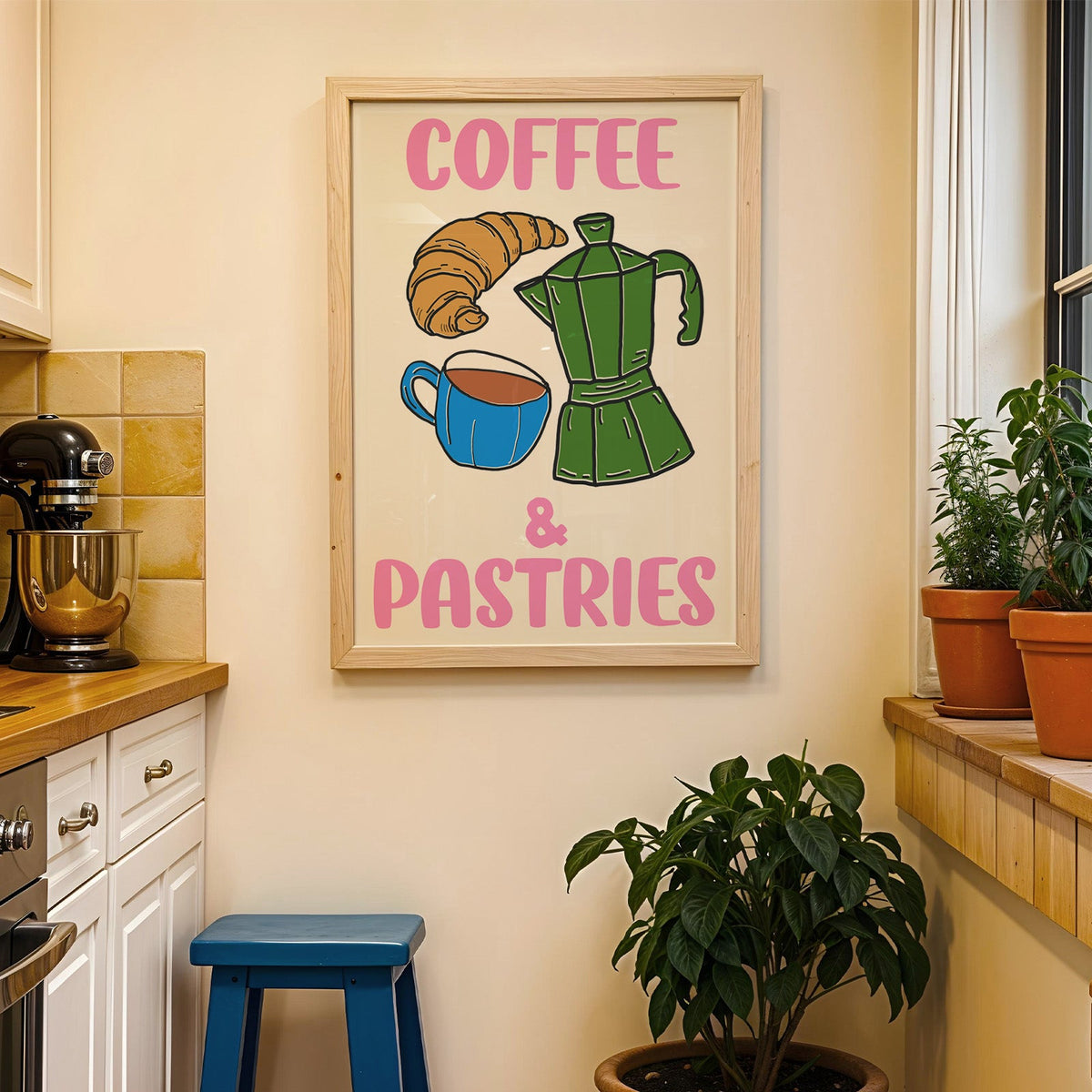 Coffee and pastries print in a wood frame on a yellow tiled kitchen wall