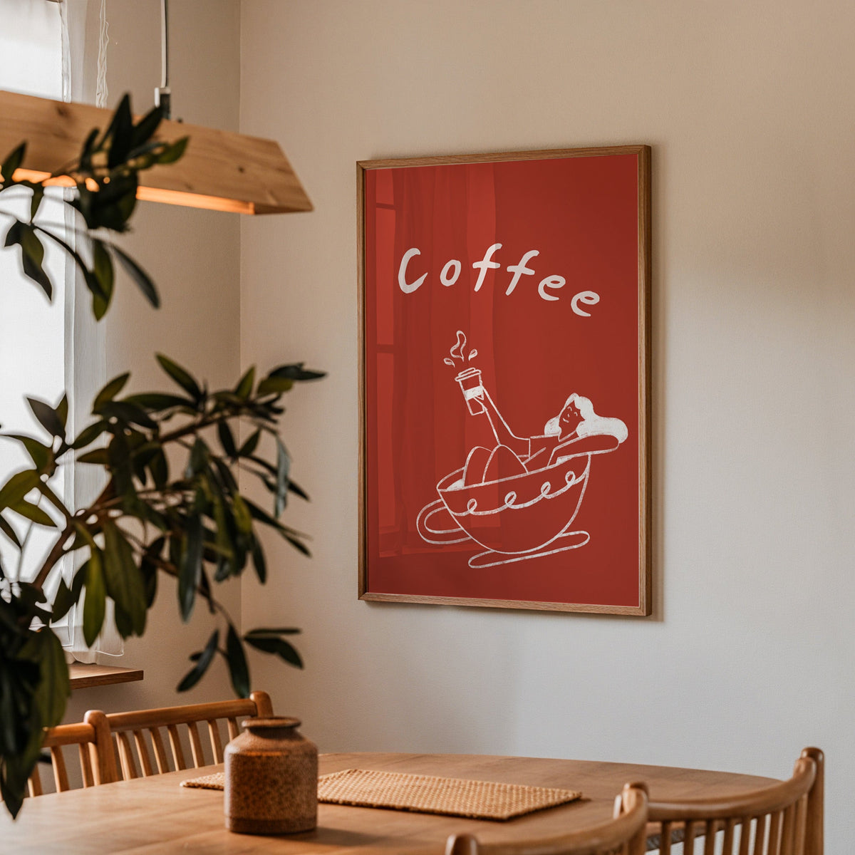 Coffee Bath print in a walnut frame above a dining table with olive branches