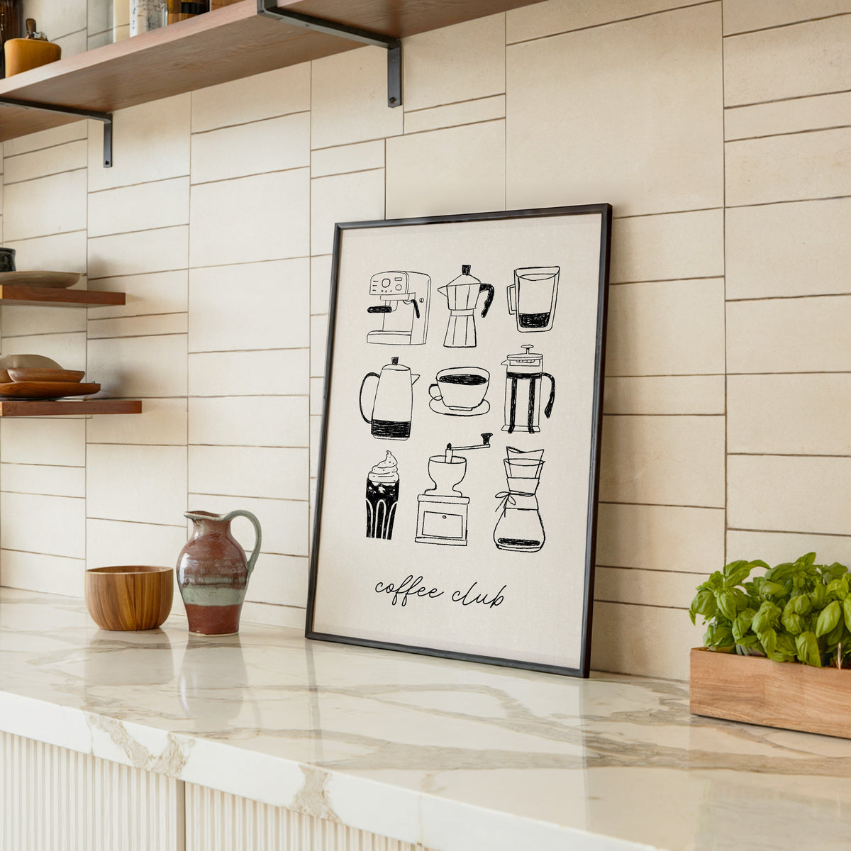 Coffee Club brewer grid print in a black frame leaning on a marble counter in a tiled kitchen