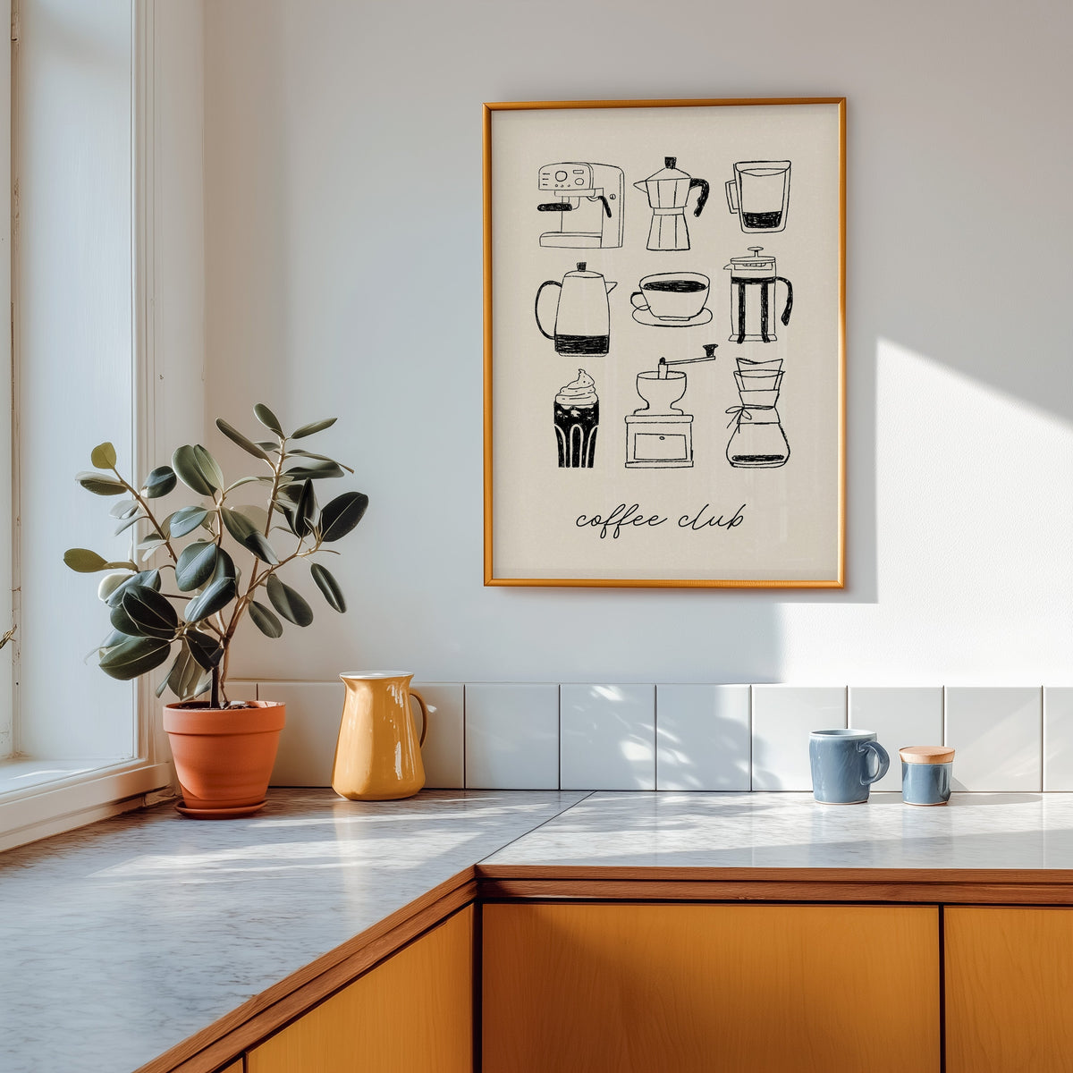 Coffee Club brewer grid print shown in a gold frame above a marble counter in a tan kitchen