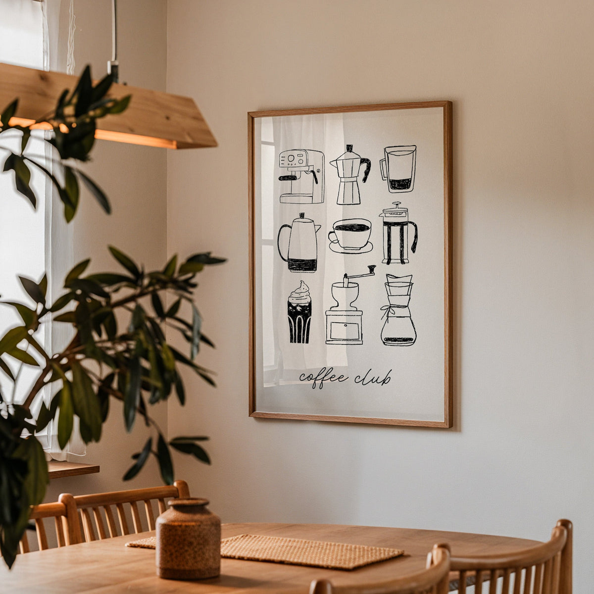 Coffee Club brewer grid print in a walnut frame above a dining table with olive branches
