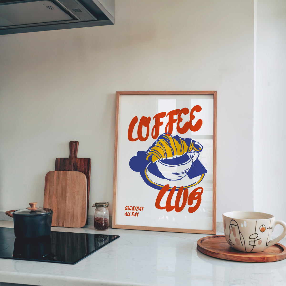 Coffee Club croissant print in a pine frame on a marble kitchen counter